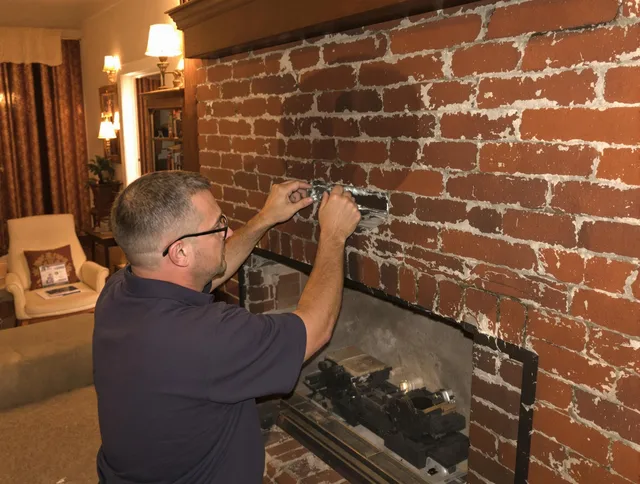 Willimantic Chimney Sweep expert fixing a fireplace in Willimantic, CT